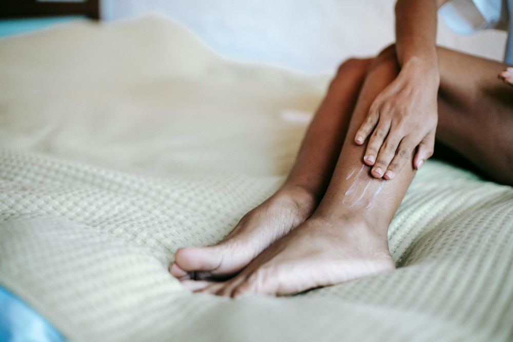 woman applying leg cream