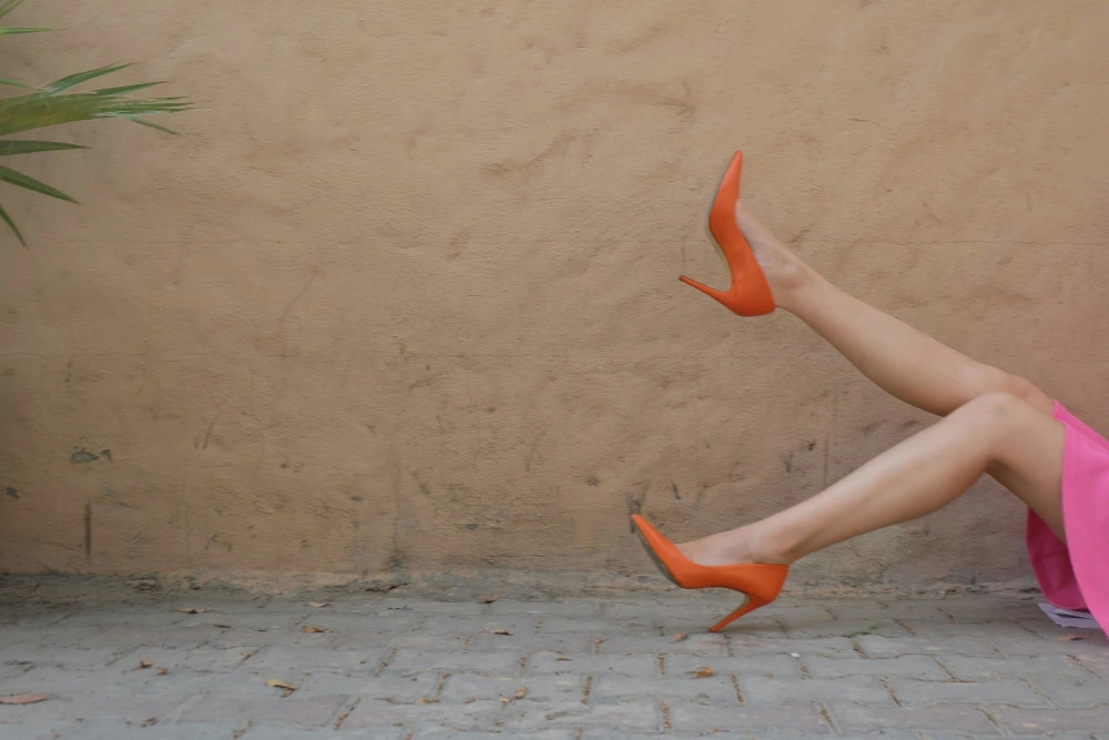 woman with orange high heels - tvs